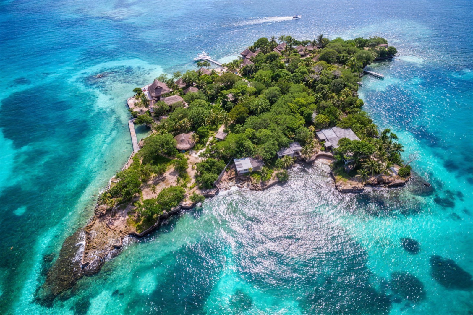 Aerial view of a small private island ringed by turquoise water in the Islas del Rosario